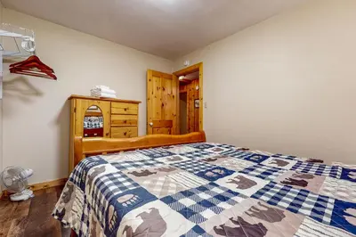 a bedroom with a bed with a blue and white quilt at Donner Escape in South Lake Tahoe