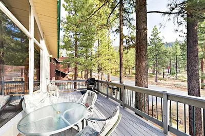 a patio with a glass table and chairs on a porch at Donner Escape in South Lake Tahoe