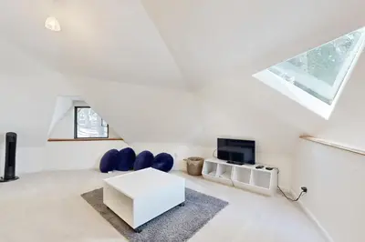 a white living room with a white table and blue chairs at Chamonix Escape in Truckee