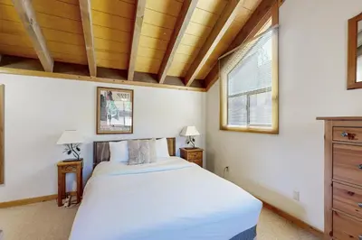 a bedroom with a bed and a wooden ceiling at Rocky Point Charms in Truckee