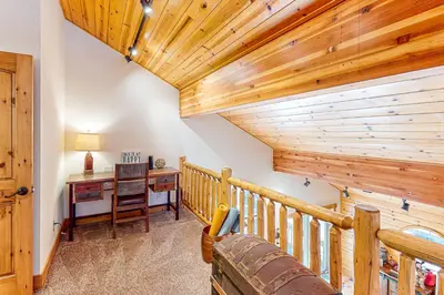 a home office with a desk and a wooden ceiling at The Bear's Lair House in Truckee