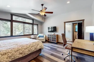 a bedroom with a bed and a ceiling fan at Arrowhead Adventures in South Lake Tahoe