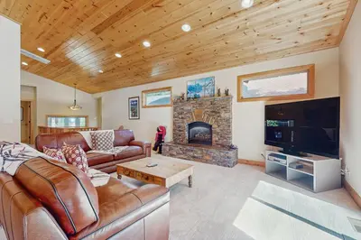 a living room with a couch and a fireplace at Willow Creek Hideway in Tahoma