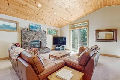 a living room with leather furniture and a fireplace at Willow Creek Hideway in Tahoma