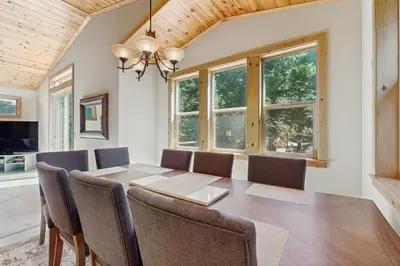 a dining room with a table and chairs at Willow Creek Hideway in Tahoma