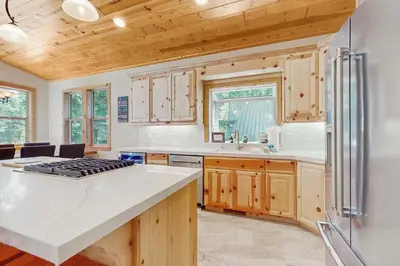 a kitchen with wooden cabinets and a counter top at Willow Creek Hideway in Tahoma