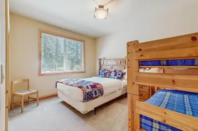 a bedroom with two bunk beds and a window at Willow Creek Hideway in Tahoma