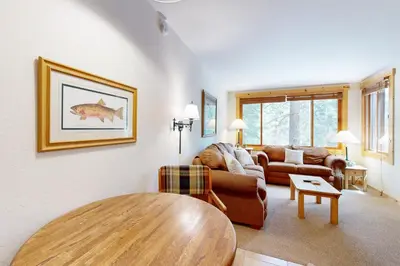 a living room with a couch and a table at Slopeside Adventures in Truckee