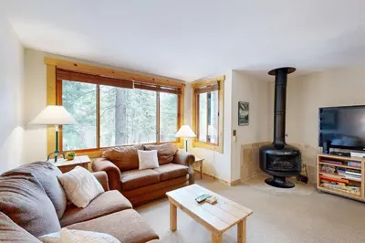 a living room with a couch and a wood stove at Slopeside Adventures in Truckee