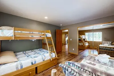 a bedroom with two bunk beds and a mirror at Cochise Adventures in South Lake Tahoe
