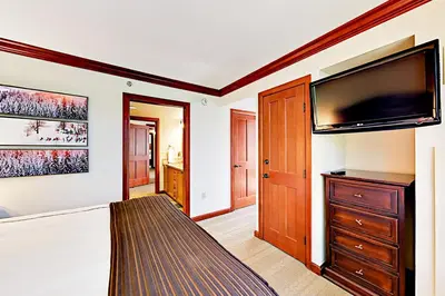 a living room with a large flat screen tv at Resort at Squaw Creek's 556, 558, & 560 in Olympic Valley