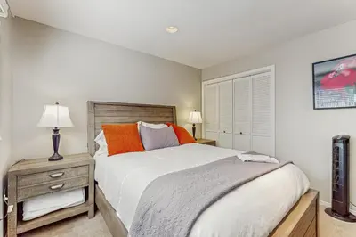 a bedroom with a bed and a table with a nightstand at Azure Palace in South Lake Tahoe