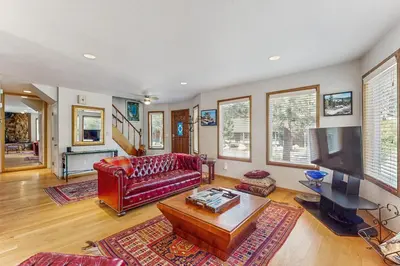 a living room with a red couch and a tv at Azure Palace in South Lake Tahoe