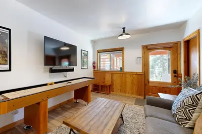 a living room with a ping pong table at Spectacular Lakeview Cabin in Kings Beach