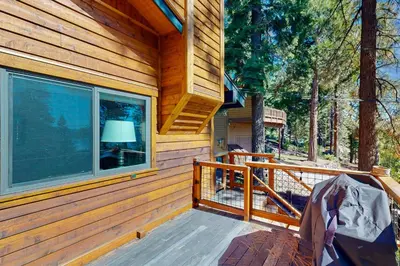 a porch of a wooden cabin with a window at Spectacular Lakeview Cabin in Kings Beach