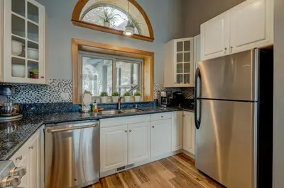 a kitchen with white cabinets and a stainless steel refrigerator at Heaven by the Lake in Truckee