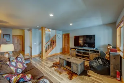 a living room with a couch and a flat screen tv at Heaven by the Lake in Truckee