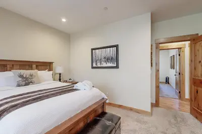 a bedroom with a large bed and a hallway at Thunderbird Palace in South Lake Tahoe
