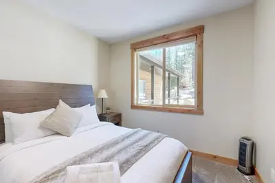 a bedroom with a large bed and a window at Thunderbird Palace in South Lake Tahoe