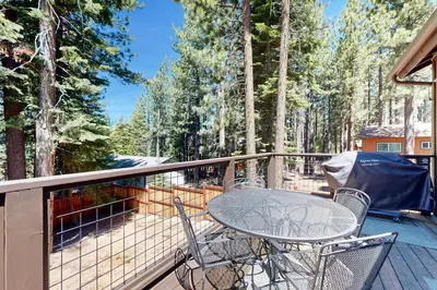 a patio with a table and chairs on a deck at Thunderbird Palace in South Lake Tahoe