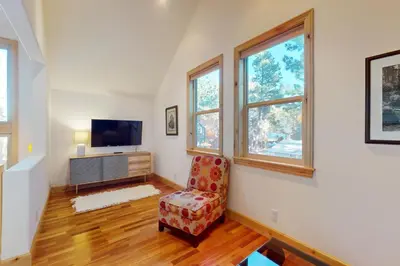 a living room with a chair and a television at Cottage Charms in South Lake Tahoe