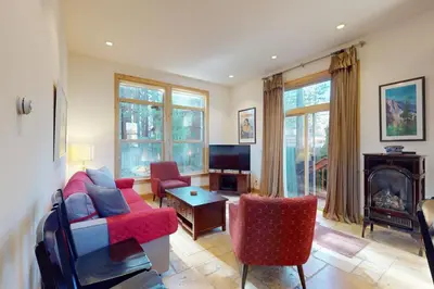 a living room with a couch and chairs and a fireplace at Cottage Charms in South Lake Tahoe
