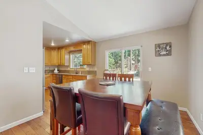 a kitchen with a large wooden table and chairs at Backyard Oasis in South Lake Tahoe