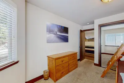 a bedroom with a wooden dresser and a window at Jacarillo Escape in South Lake Tahoe
