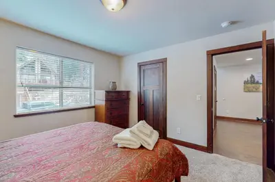a bedroom with a bed and a dresser and a window at Jacarillo Escape in South Lake Tahoe