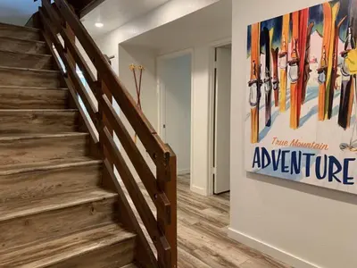 a staircase with a painting of skis on the wall at Rr-edgewater04 in June Lake