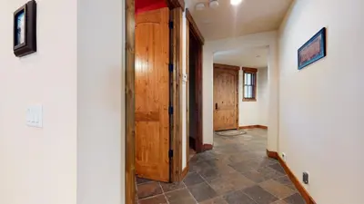 a hallway with wooden doors and a tile floor at Snowcreek VI The Lodges #1133 condo in Mammoth Lakes