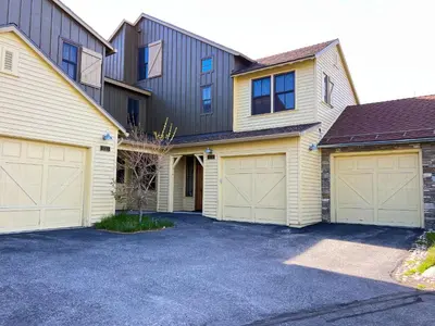 a house with two garages and two garage doors at Snowcreek VI The Lodges #1133 condo in Mammoth Lakes