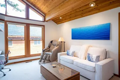 a living room with a couch and a table at Creekside at Northstar home in Truckee