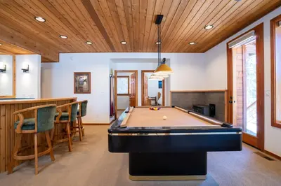 a pool table in a room with a bar at Creekside at Northstar home in Truckee