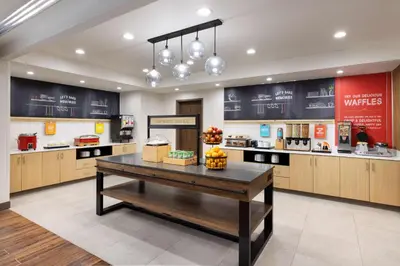 a large kitchen with a table in the middle at Hampton Inn Oakhurst-Yosemite in Oakhurst