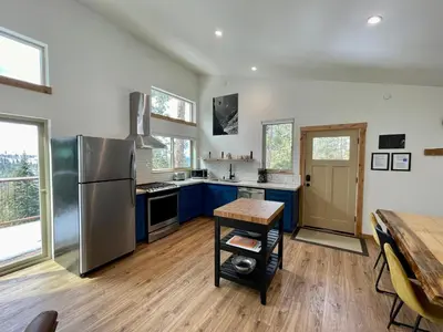 a kitchen with blue cabinets and a stainless steel refrigerator at Ravens Lair in Yosemite West