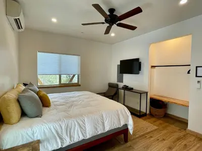 a bedroom with a bed with a ceiling fan at Ravens Lair in Yosemite West