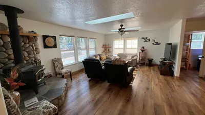 a living room with a couch and a fireplace at Cozy Cabin in Arnold ! in Arnold