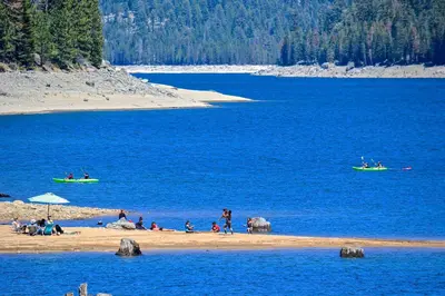 a group of people on a beach with boats in the water at Livin' The Dream at 7000 ft in Lakeshore