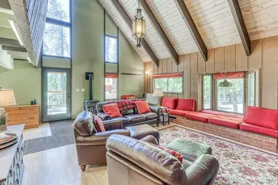 a living room with leather furniture and windows at Livin' The Dream at 7000 ft in Lakeshore