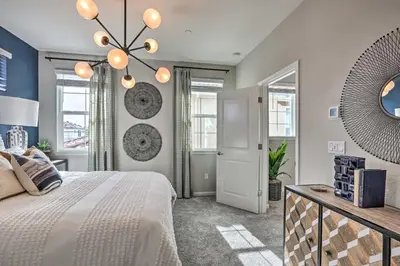 a bedroom with a large bed and a chandelier at Relaxing Roseville Home with Outdoor Amenities in Roseville