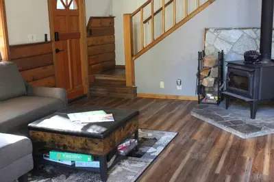 a living room with a couch and a wood stove at Fully updated Truckee cabin with plenty of beds in Truckee