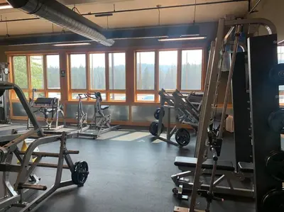 a gym with several exercise bikes in a room with windows at Fully updated Truckee cabin with plenty of beds in Truckee
