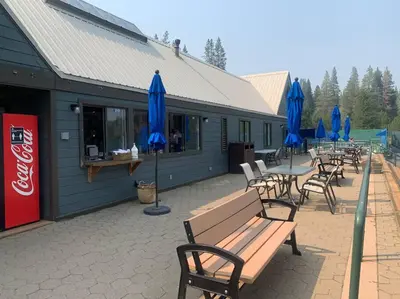 a group of tables and chairs with blue umbrellas at Fully updated Truckee cabin with plenty of beds in Truckee