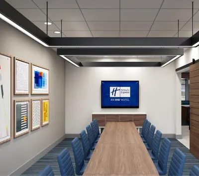 a conference room with a long table and blue chairs at Holiday Inn Express & Suites - Hollister by IHG in Hollister
