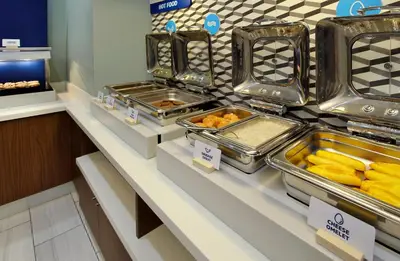 a buffet line with trays of food on display at Holiday Inn Express & Suites - Hollister by IHG in Hollister