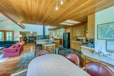 a kitchen and living room with wooden ceilings at Cascadel Haven in North Fork