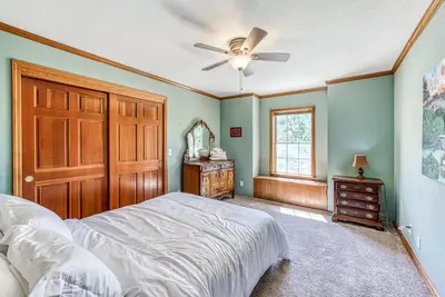 a bedroom with a bed and a ceiling fan at Cascadel Haven in North Fork