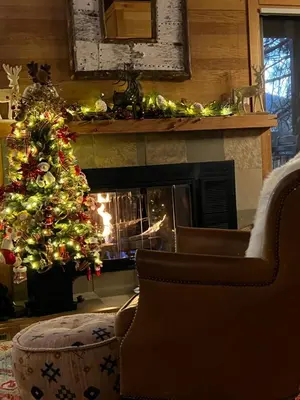 a christmas tree in a living room with a fireplace at Indian Hills Gem Awaits in Truckee