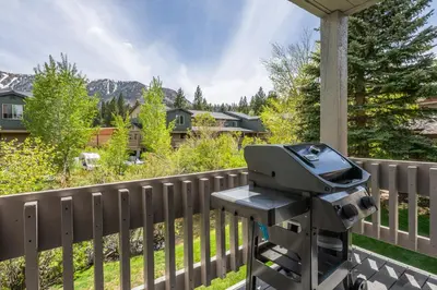 a grill on a porch with a fence at Snowcreek IV 549 in Mammoth Lakes